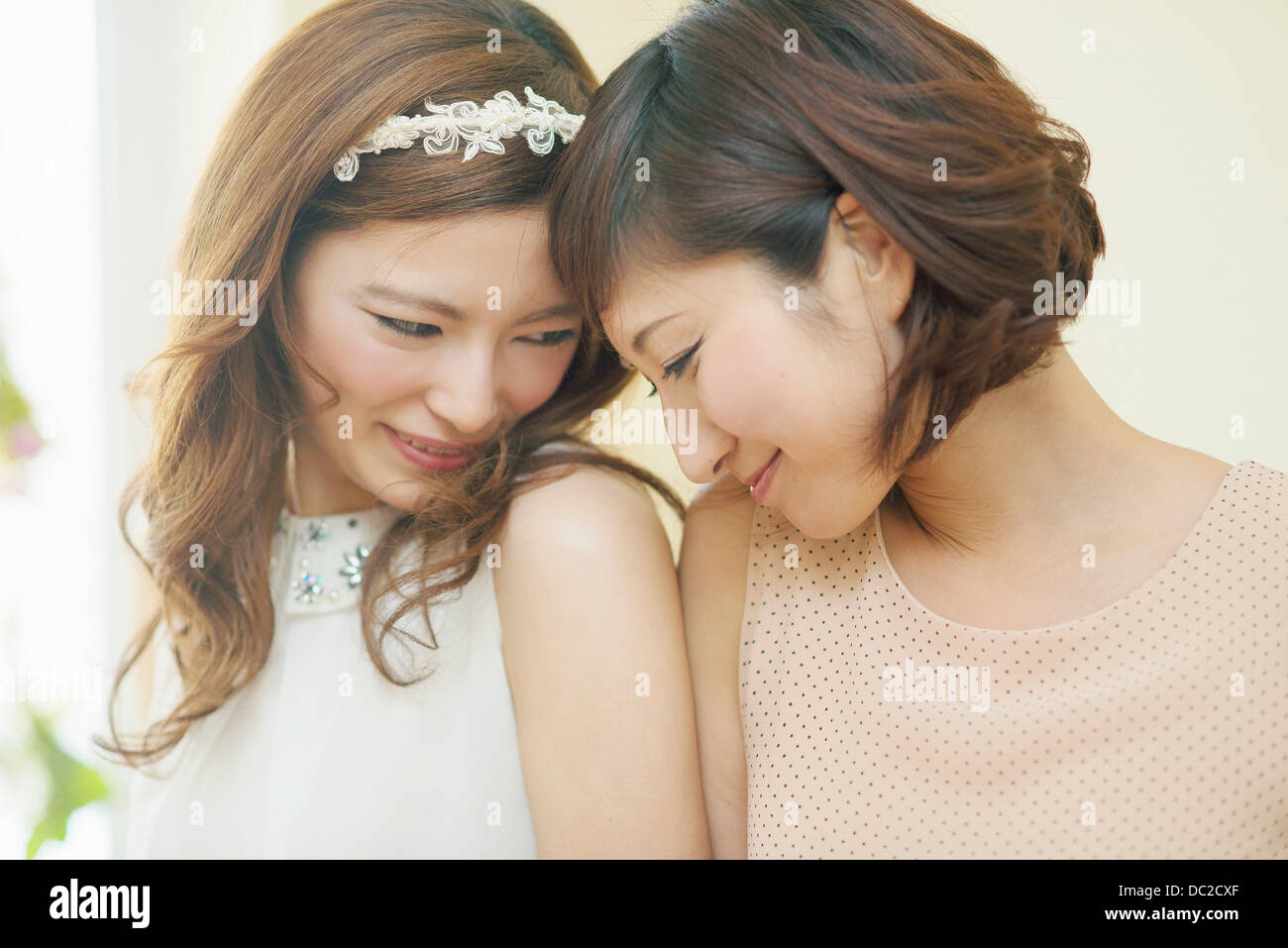 Two women nuzzling foreheads Stock Photo