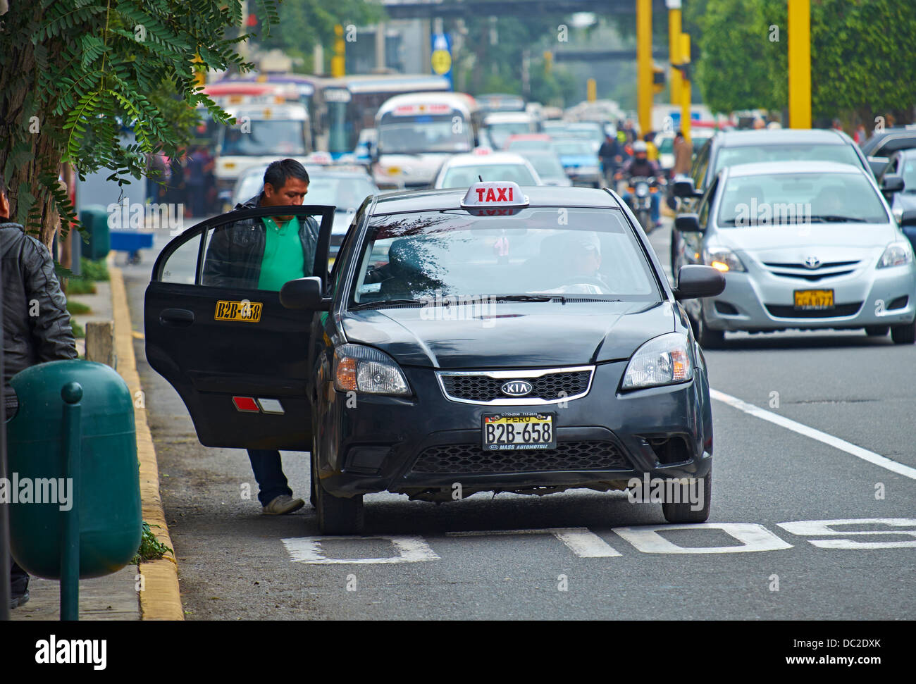 A Man Getting Into A Taxi, Miraflores district of Lima, Peru. Stock Photo