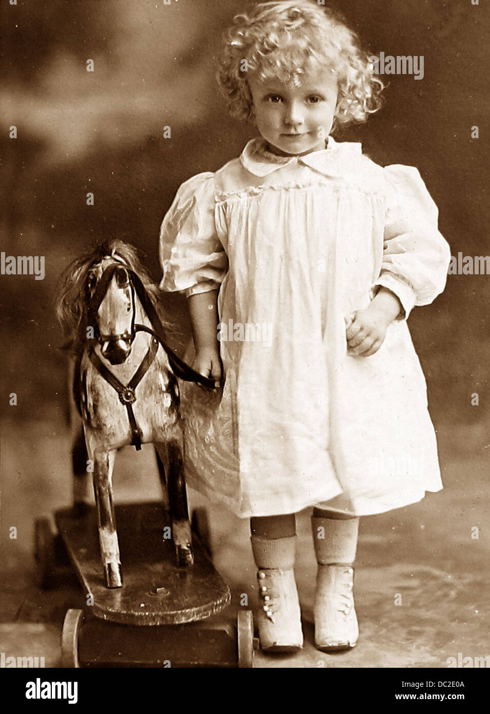 Boy or girl with toy horse Studio photo Victorian period Stock Photo