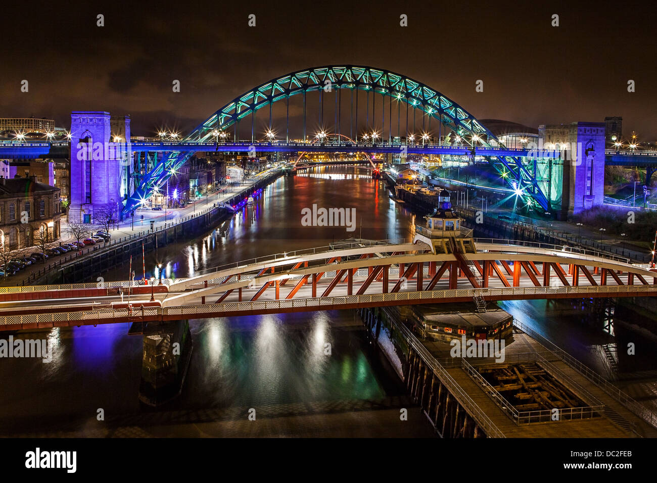 River Tyne bridges in Newcastle/Gateshead taken on a long exposure at night showing the bridges illuminated in colour Stock Photo