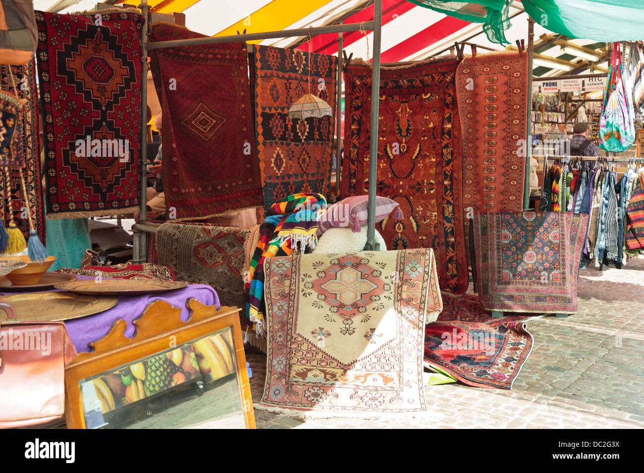 Carpets rugs for sale in market stall, Cambridge, England Stock Photo