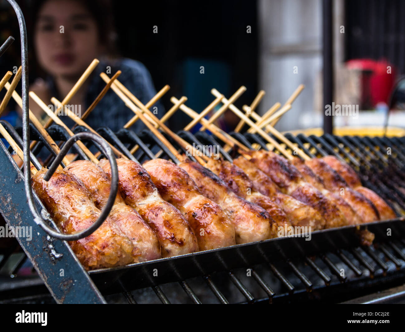Thai sausage cooking in a market Stock Photo