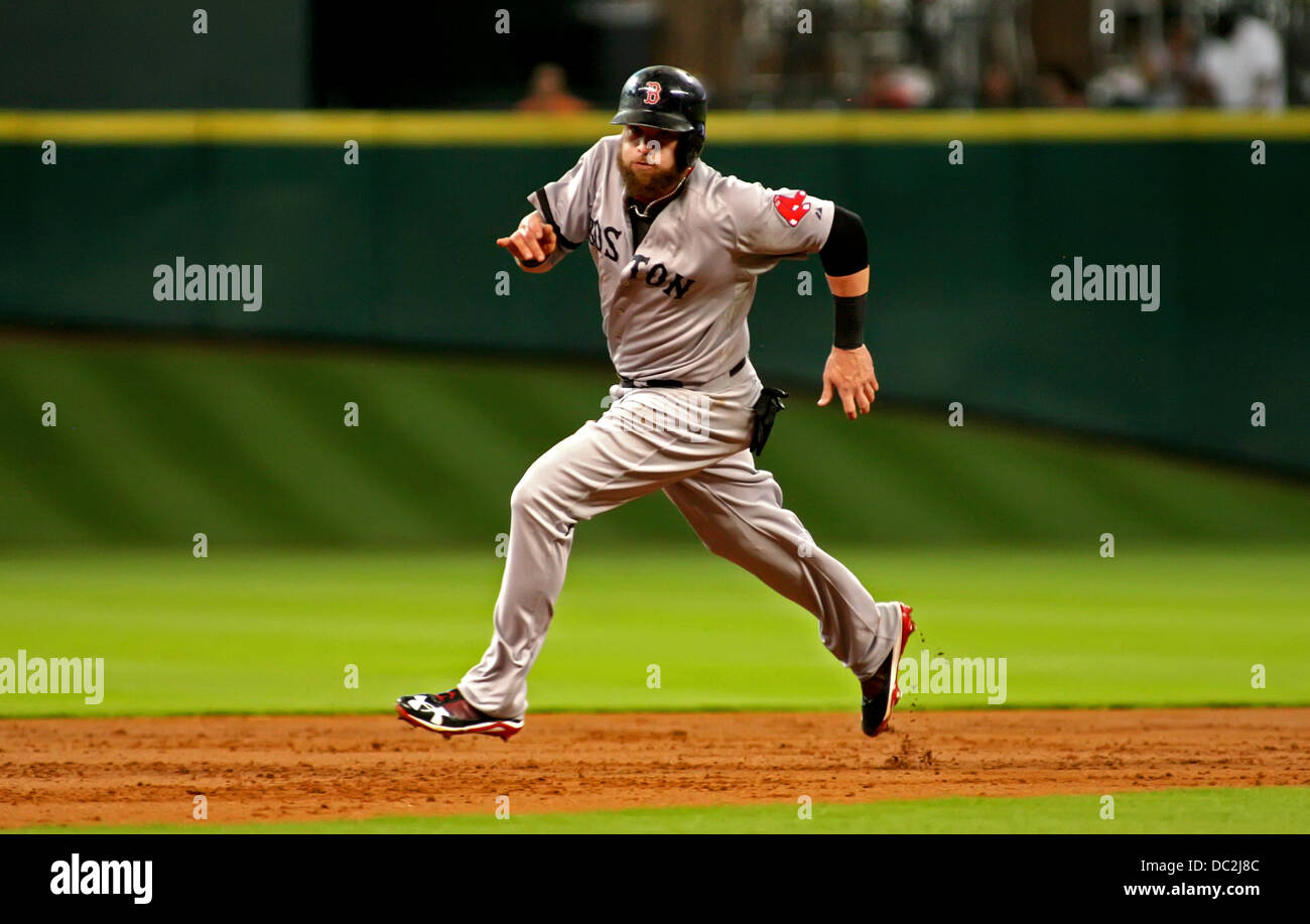 Boston Red Sox Jonny Gomes (R) slides in safe at home under the