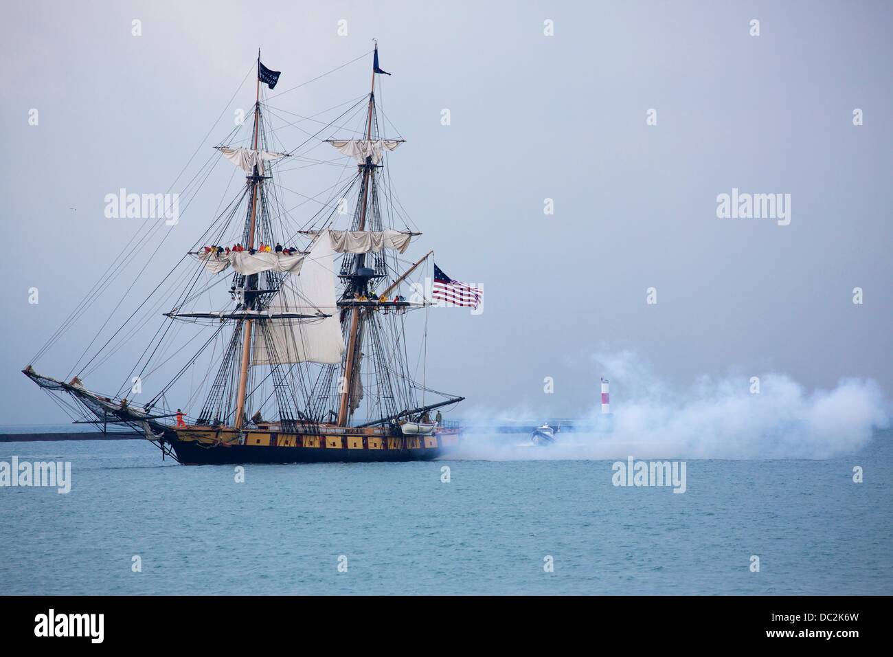 Chicago, Illinois, USA. 7th August 2013. The brig Flagship Niagara, a replica of Commodore Oliver Hazard Perry's victorious flagship at the 1813 Battle of Lake Erie, fires a canon during the parade of ships at Tall Ships 2013 in Chicago. The festival of ships runs from today until August 11 at Navy Pier. A selection of ships are available for dockside boarding and a few are available for cruises. Credit:  Todd Bannor/Alamy Live News Stock Photo