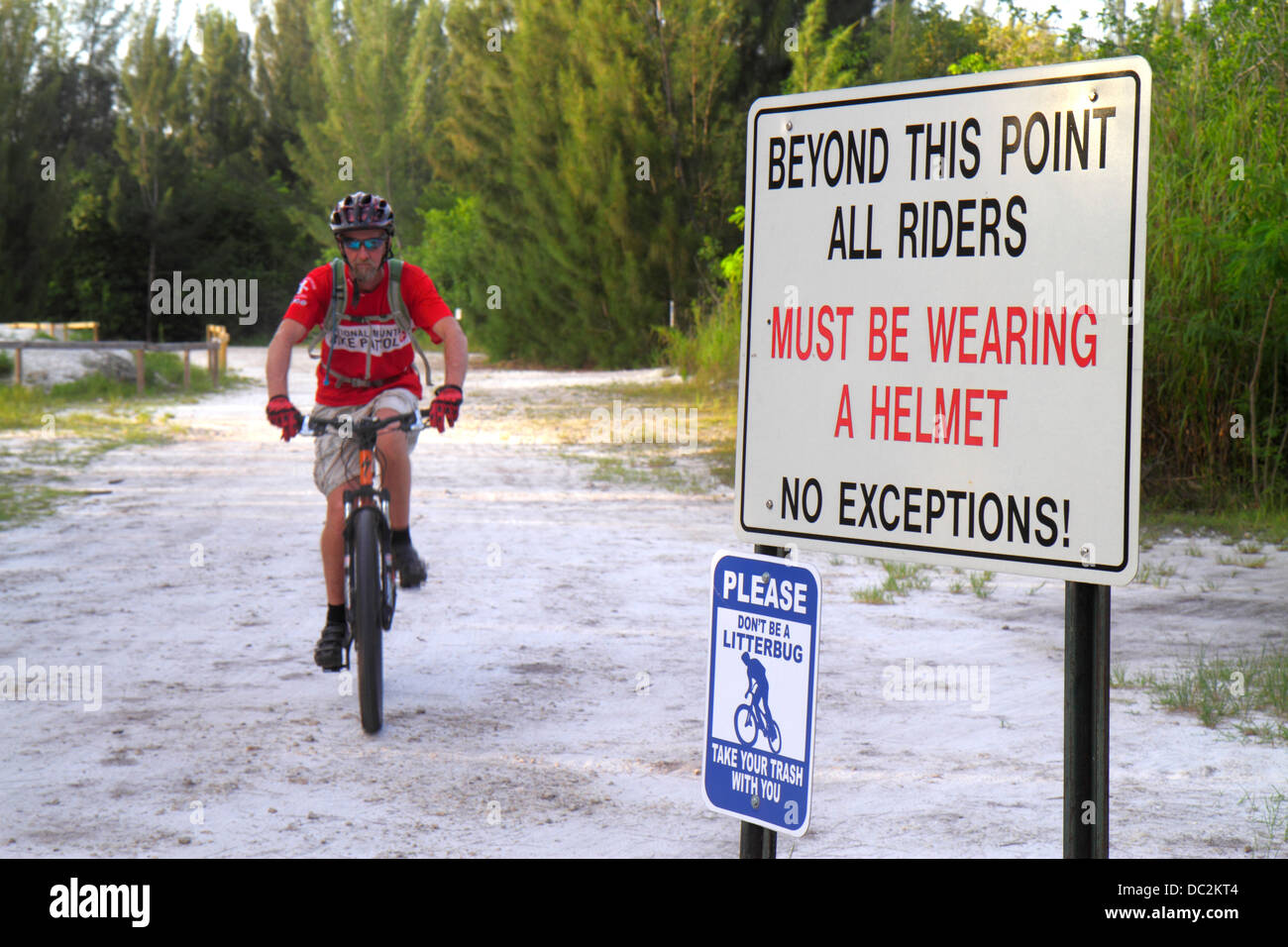 Florida Weston,Fort Ft. Lauderdale,Markham Park,mountain bike trail,bicycle,bicycling,riding,biking,rider,sign,all riders must be wear wearing helmet, Stock Photo