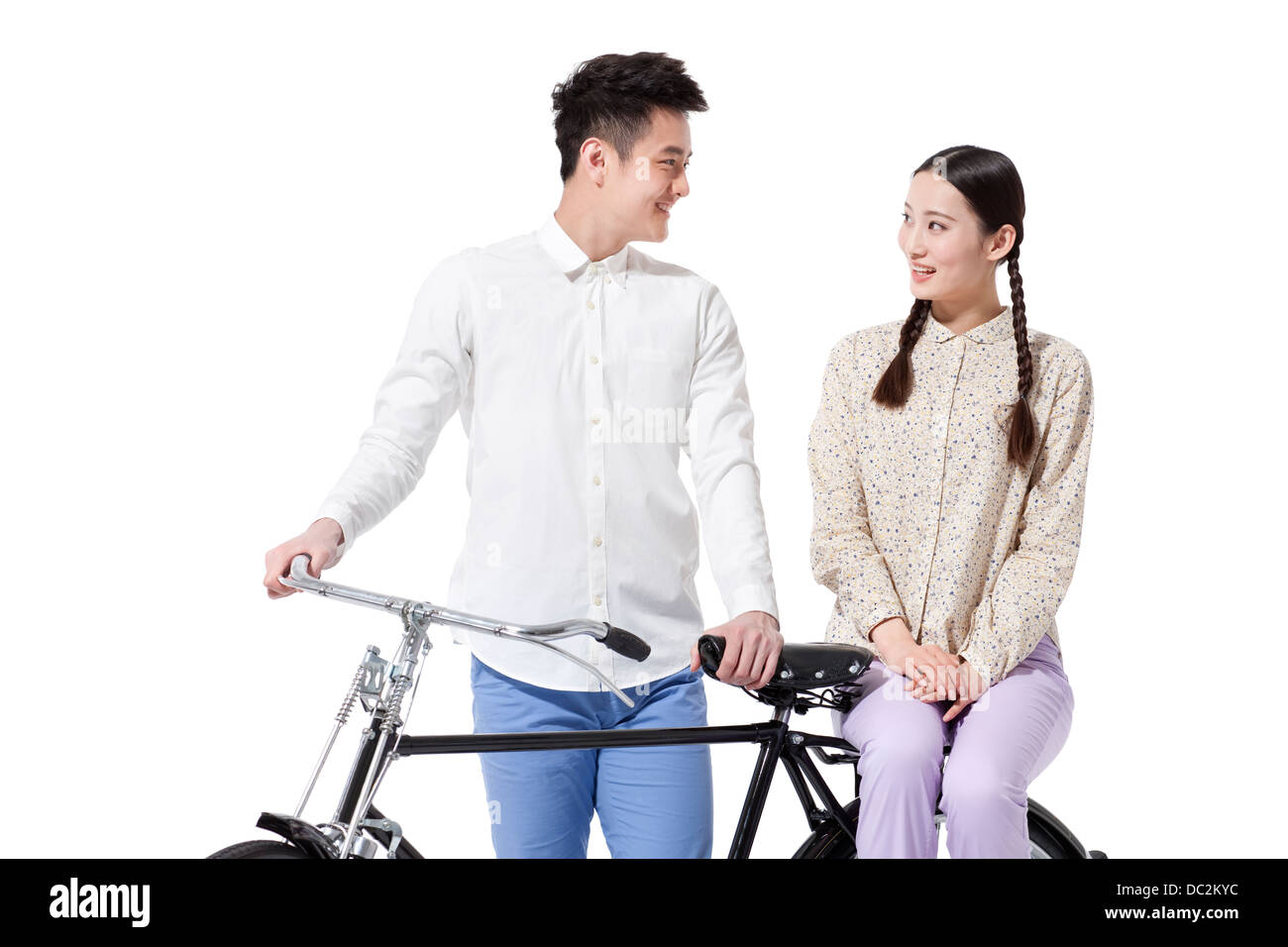 Retro couple with an old-fashioned bicycle Stock Photo - Alamy