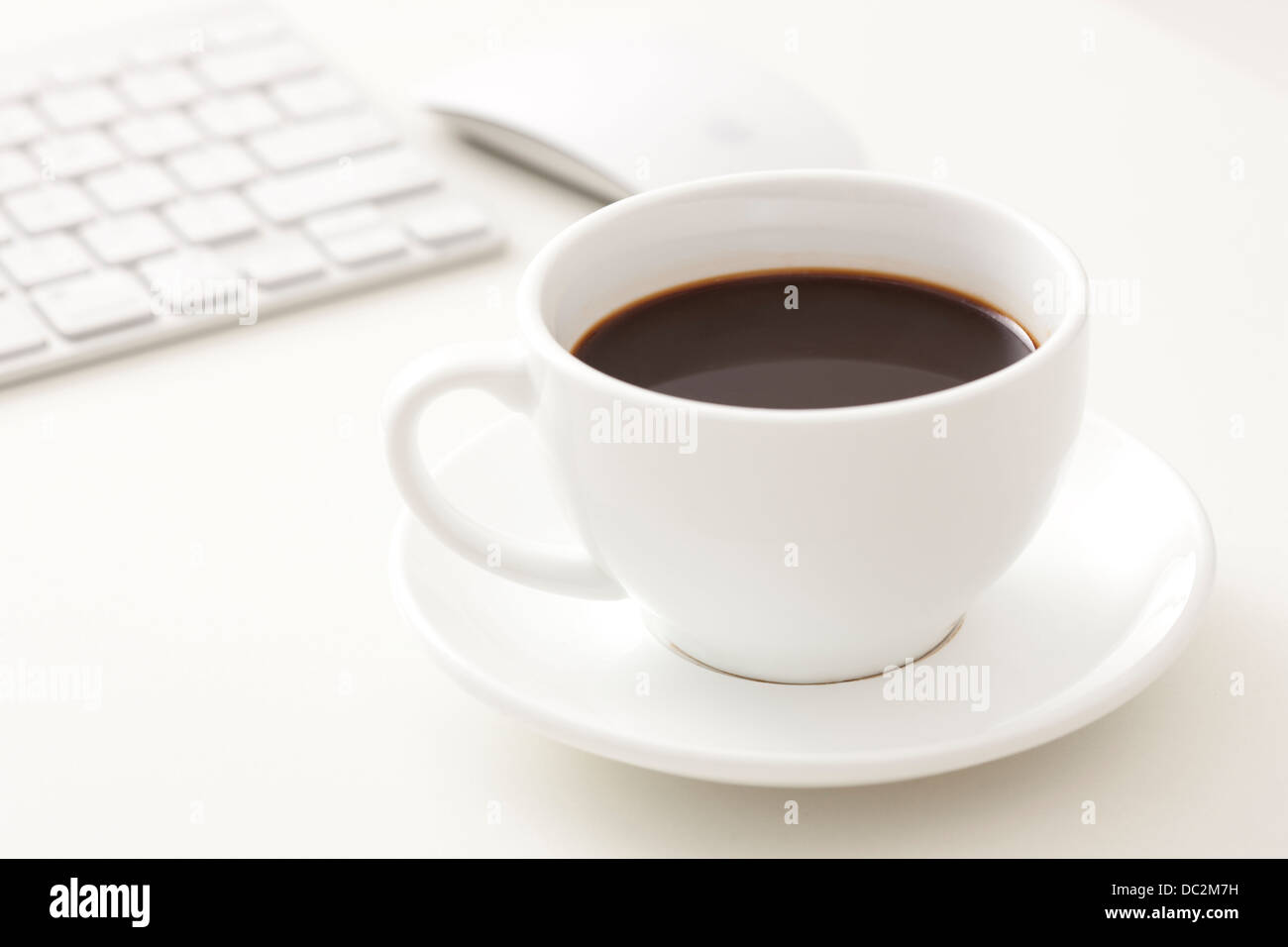 Coffee and computer on office desk Stock Photo - Alamy