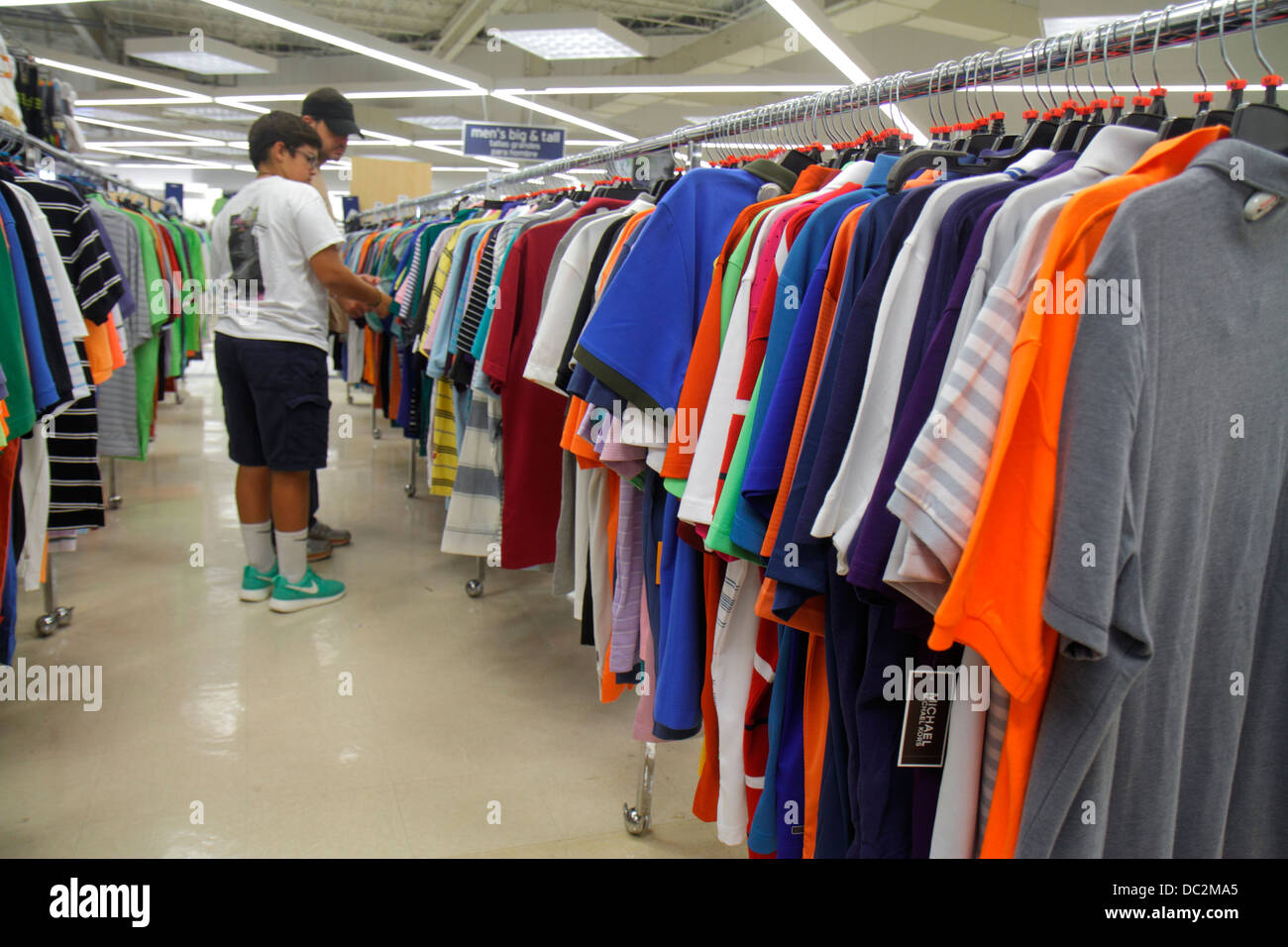 Florida Sunrise,Fort Ft. Lauderdale,Sawgrass Mills mall,sale,display sale Marshalls,discount department store,clothing,men's,shirts,rack,Hispanic boy Stock Photo