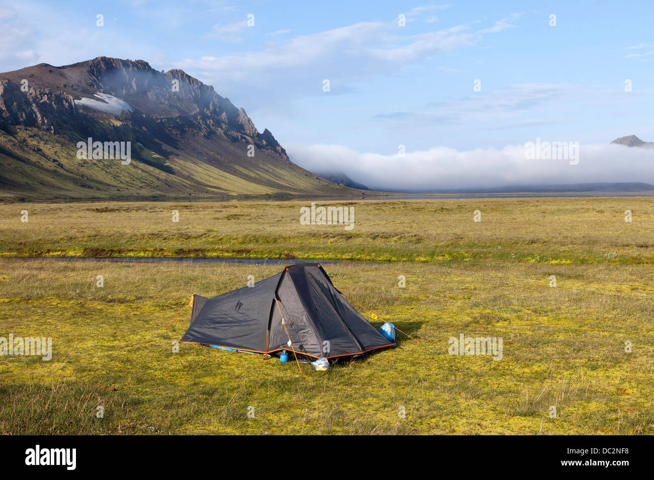 Tent on Vibrant Coloured Turf Next to Lake Alftavatn with the Mountain of Bratthals Behind Laugavegur Hiking Trail Iceland Stock Photo