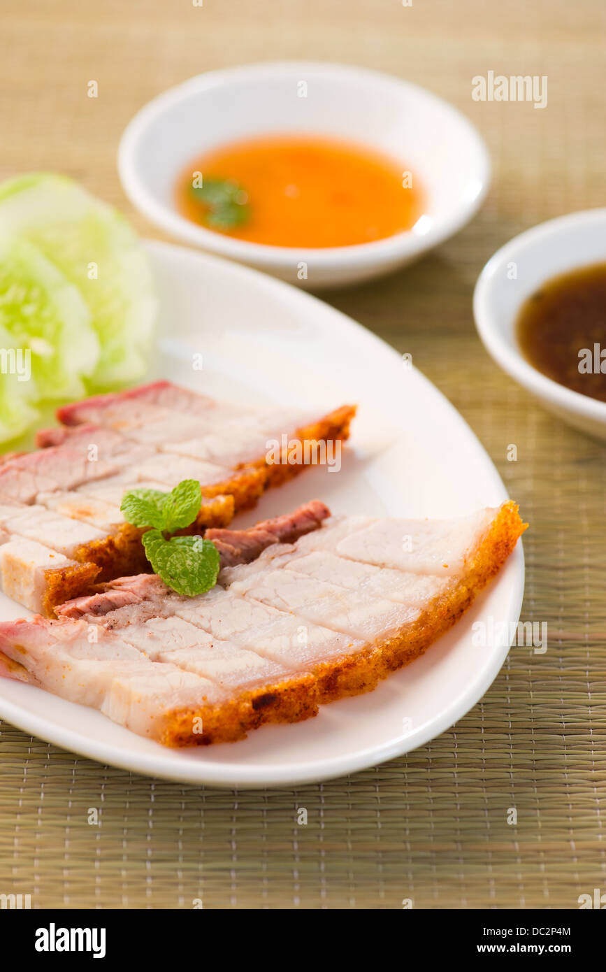 chinese roast pork close up shot served with chilli sauce Stock Photo
