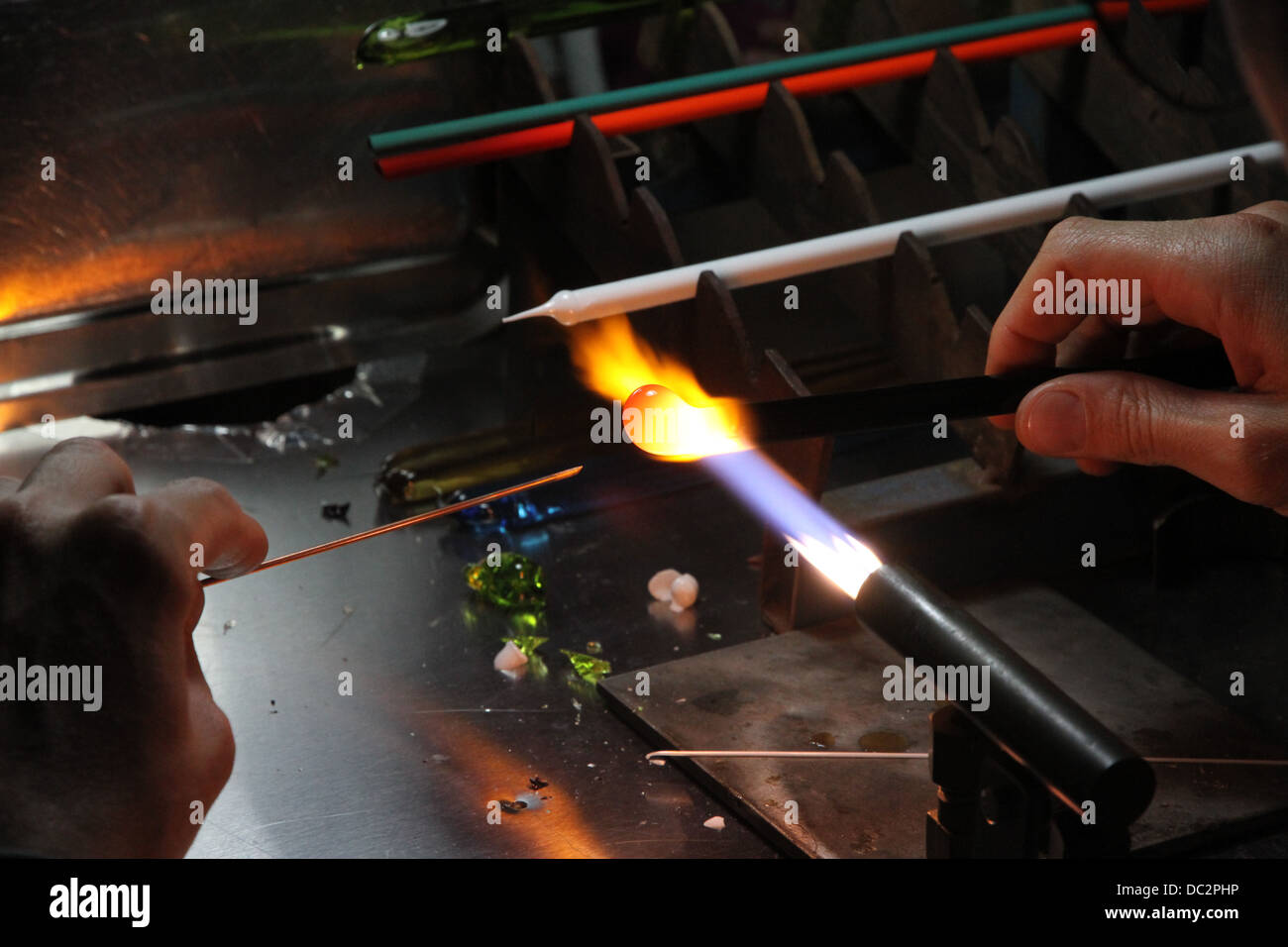 Glazier with gas torch lit while blending and shaping a piece of glass 4 Stock Photo