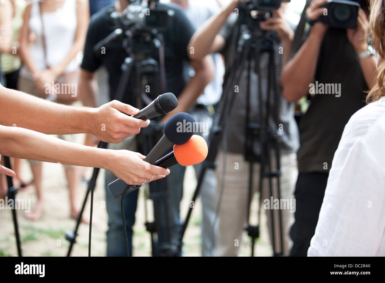 A journalist is making a interview with a microphone Stock Photo