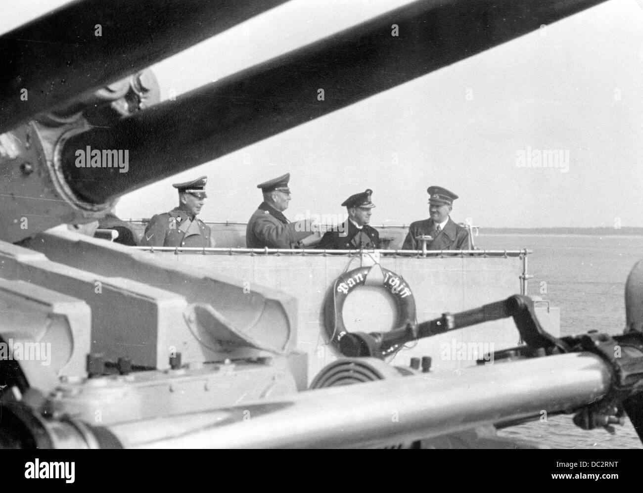 The Reich Chancellor Adolf Hitler is pictured on the battleship 'Deutschland', published on 23 March 1939. The Nazi Propaganda! on the back of the image reads: 'The Führer's trip to the Memelland on the battleship 'Deutschland'. The Führer on the bridge of the battleship 'Deutschland' accompanied by Admiral Dr.h.c. Erich Raeder (2-r), General Wilhelm Keitel (3-r), and Reich Minister Dr. Hans Heinrich Lammers (l) on a trip along the Memelland coast.' Fotoarchiv für Zeitgeschichte Stock Photo