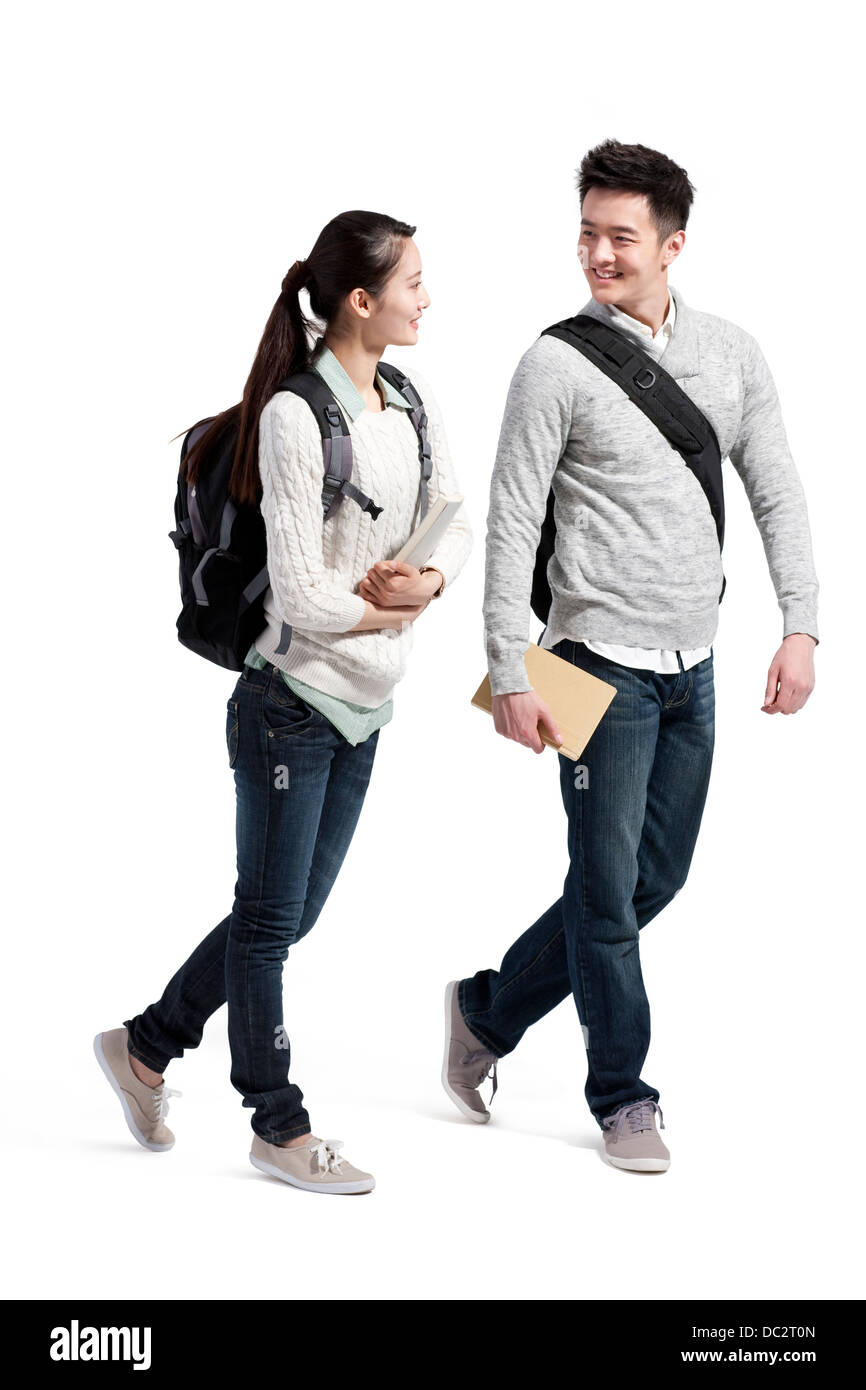 Happy college couple walking and talking Stock Photo - Alamy, image size:866x1390