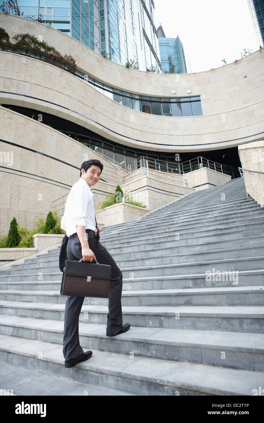businessman walking up the stairs Stock Photo - Alamy