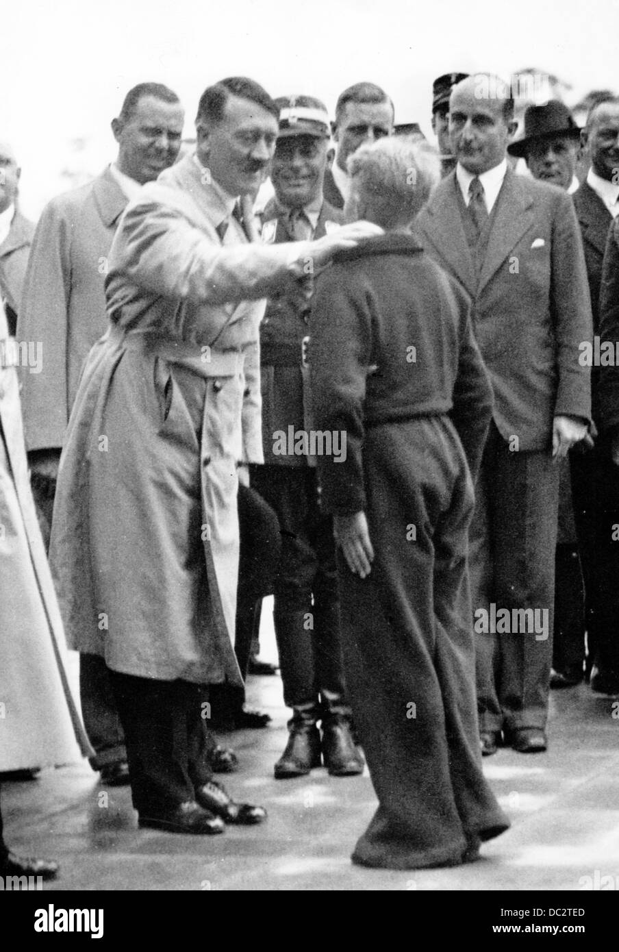 The image from the Nazi Propaganda! shows Adolf Hitler as he talks to a boy who participates in Olympic preparationg on the Reich sports field in Berlin, Germany, in 1933. Fotoarchiv für Zeitgeschichte Stock Photo