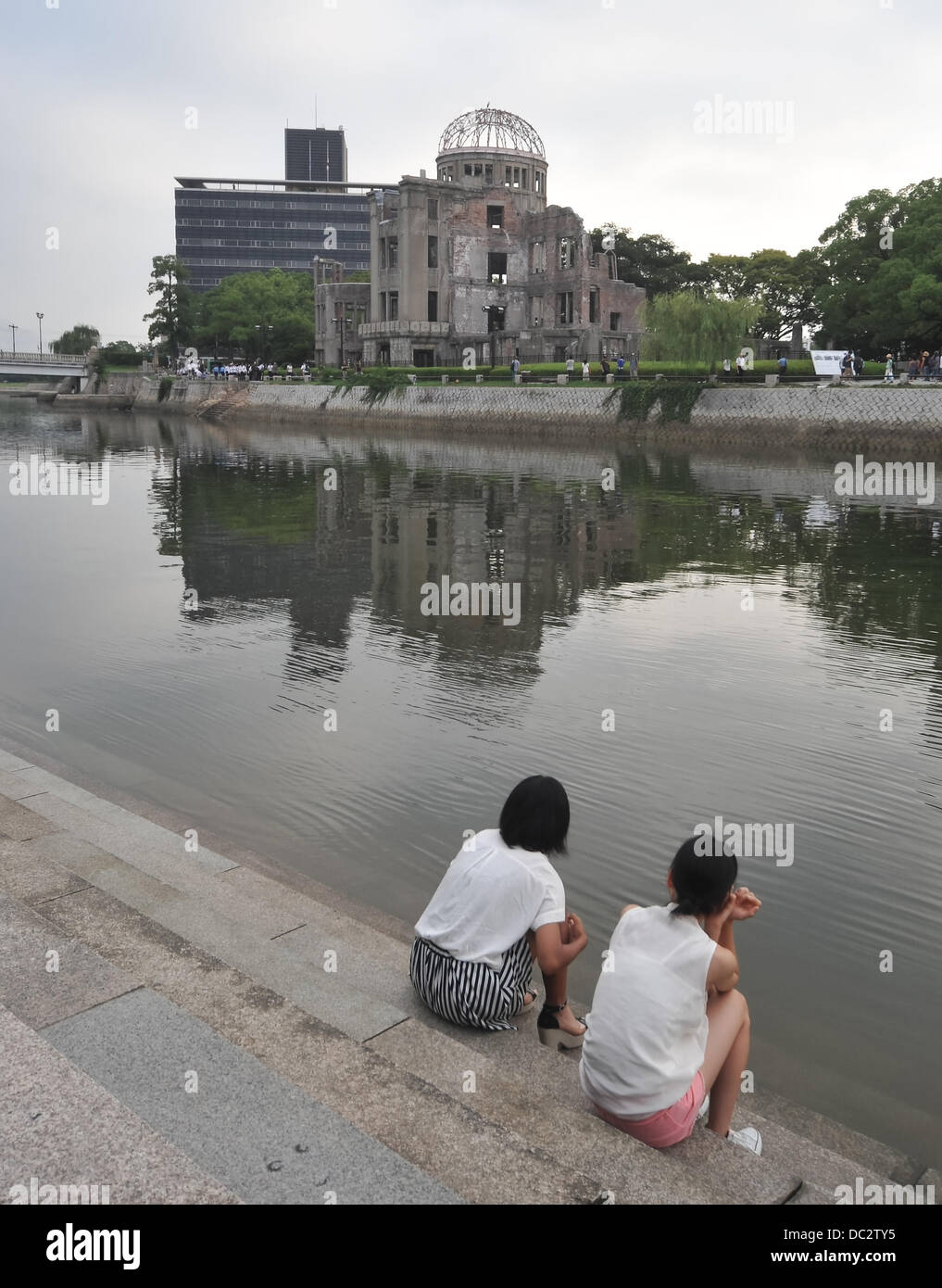 Hiroshima, Japan, August 6, 2013 Girls sit near Motoyasu River in