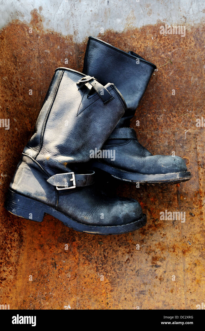 old vintage leather boots on rusty background Stock Photo
