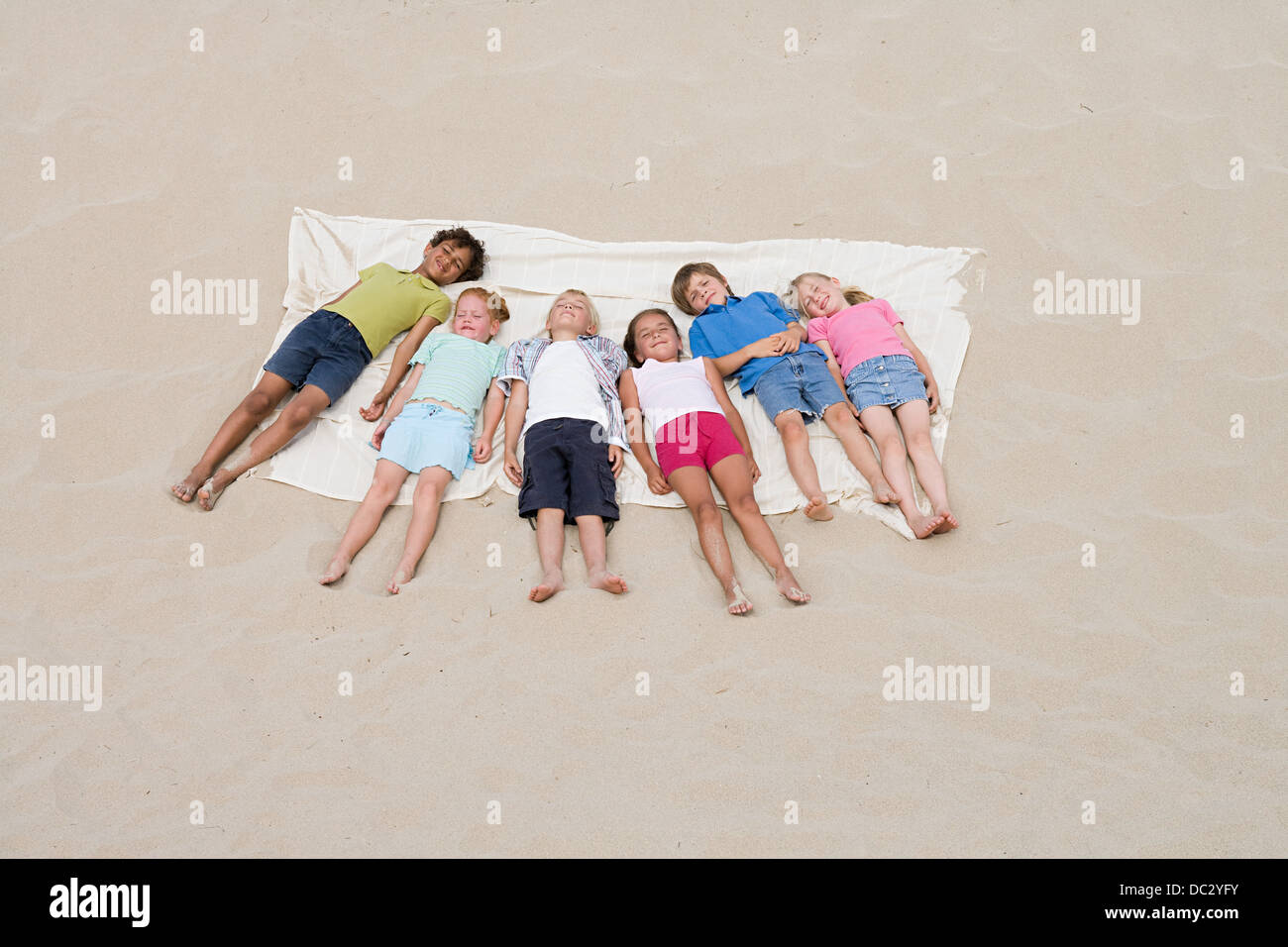 Children sleeping on the beach Stock Photo Alamy