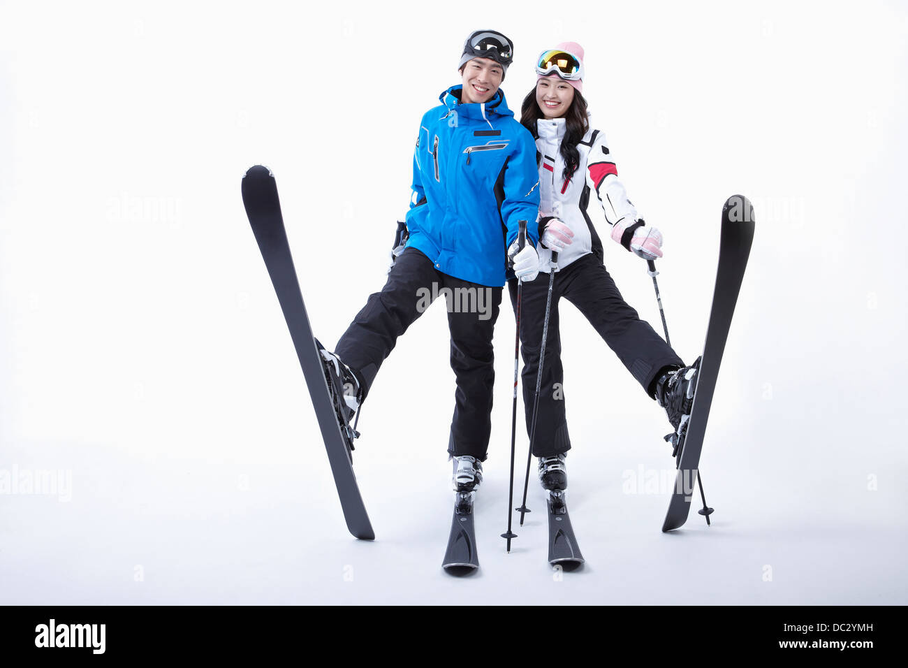a couple in ski outfit posing in white 