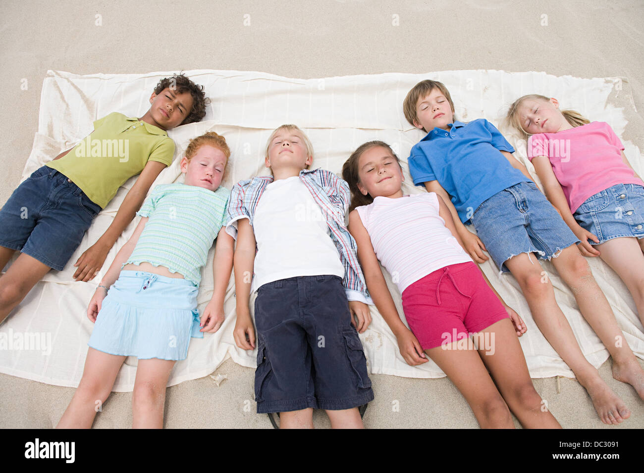 Children sleeping on the beach Stock Photo Alamy