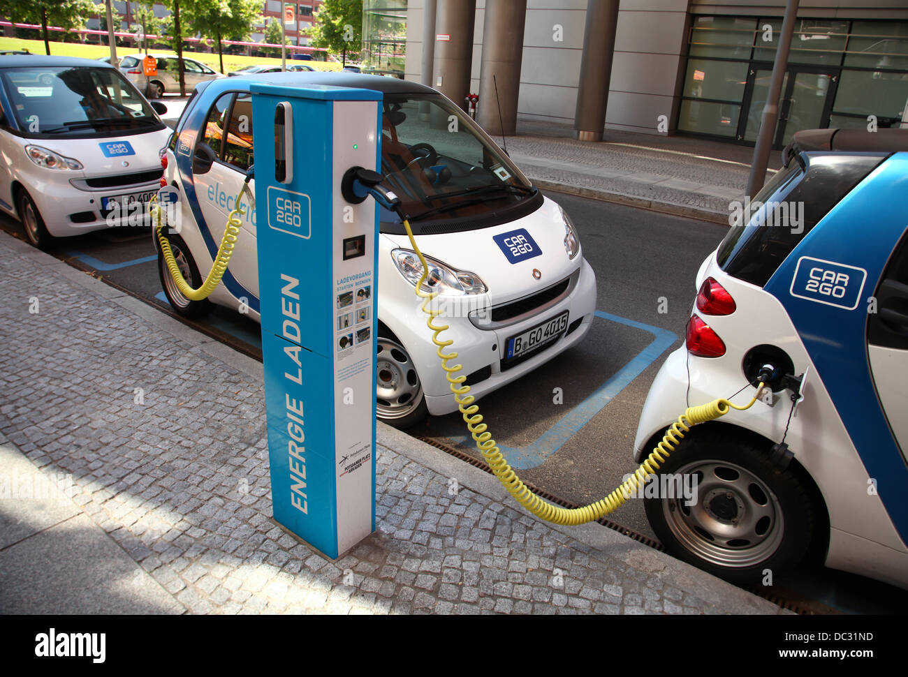 Eectric cars (Smart for two) are parked at a rental and loading station