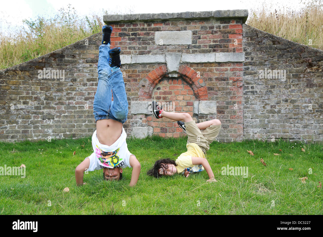 Two young boys break dancing in the park. Stock Photo
