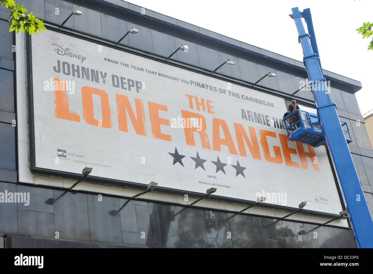 Leicester Square, London, UK. 8th August 2013. The Lone Ranger billboard is assembled above the Odeon Cinema, Leicester Square for the films opening tomorrow on the 9th August. Credit:  Matthew Chattle/Alamy Live News Stock Photo