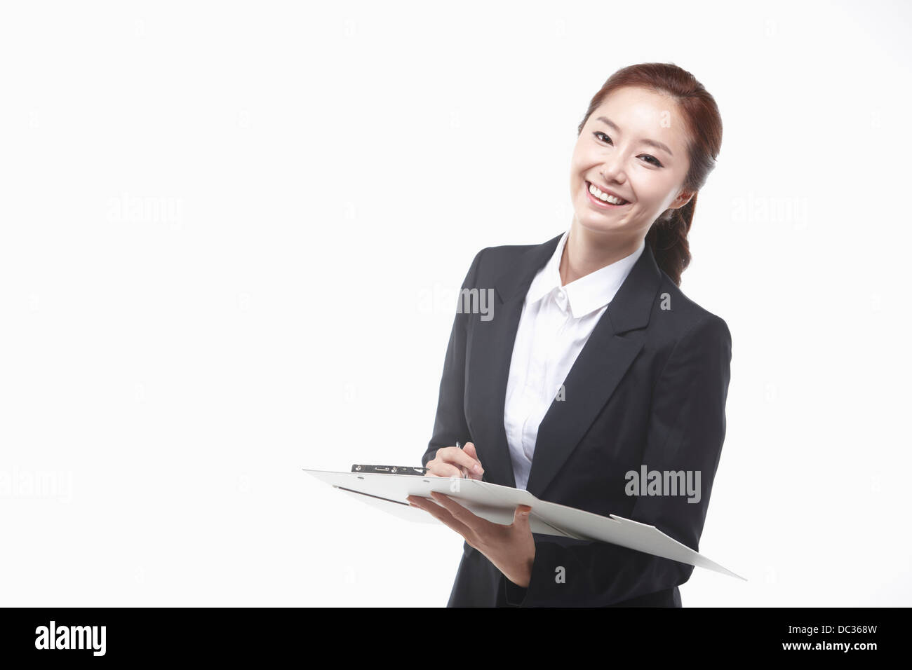 a businesswoman smiling holding folders in the white background Stock ...
