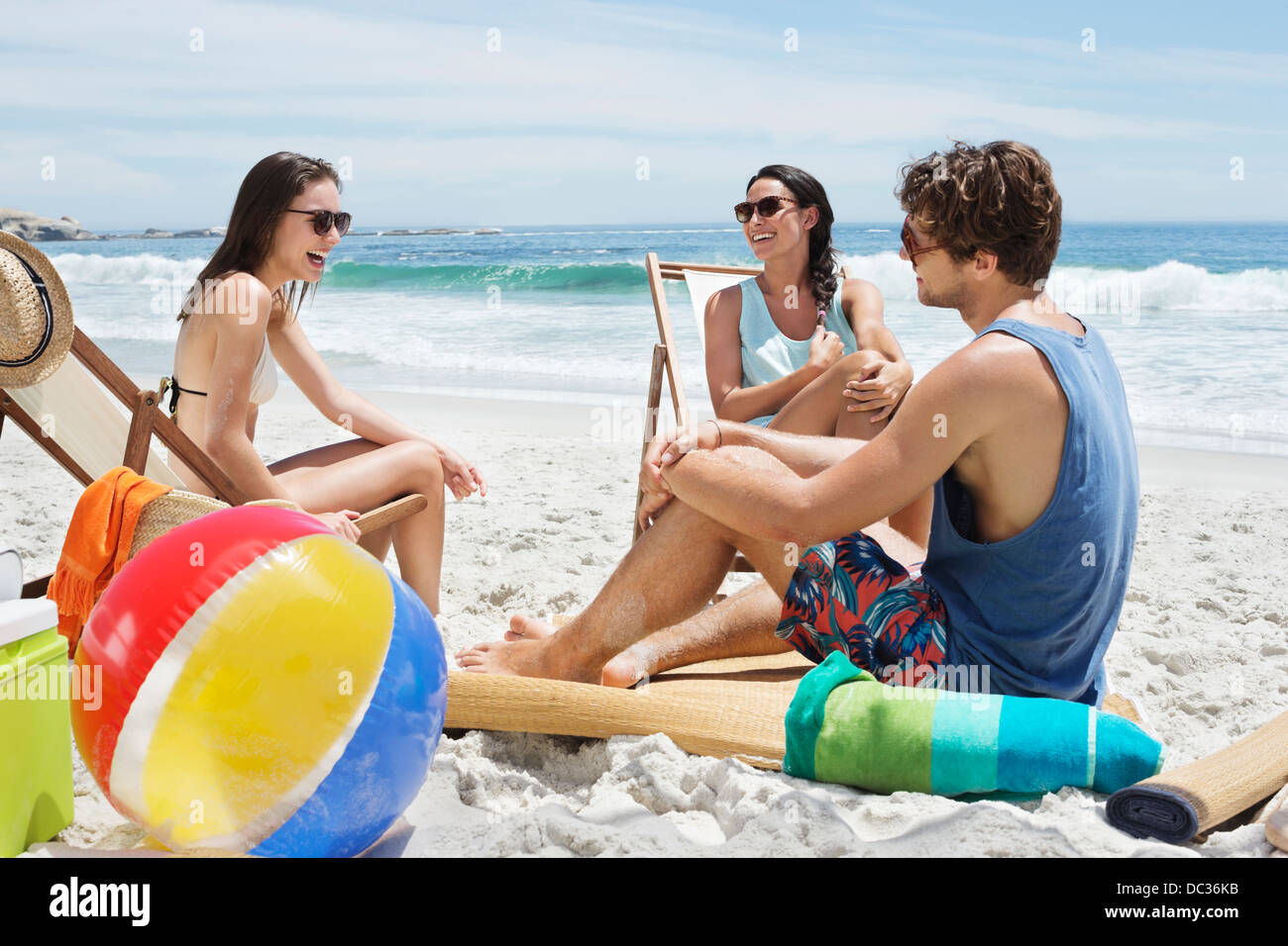 Friends hanging out at beach Stock Photo - Alamy