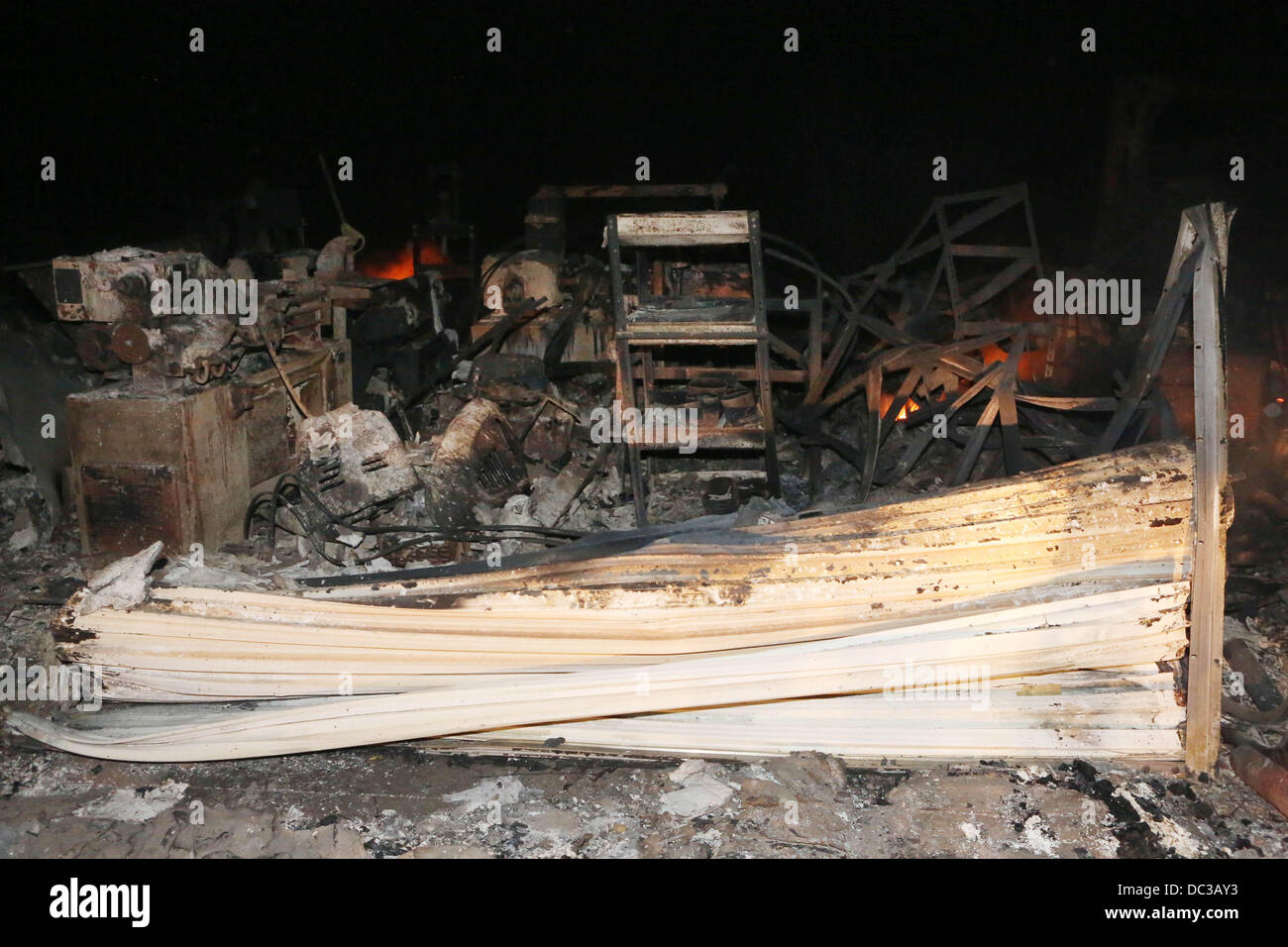 Banning, CA, USA. 7th Aug, 2013. A house burns in Twin Pines as the