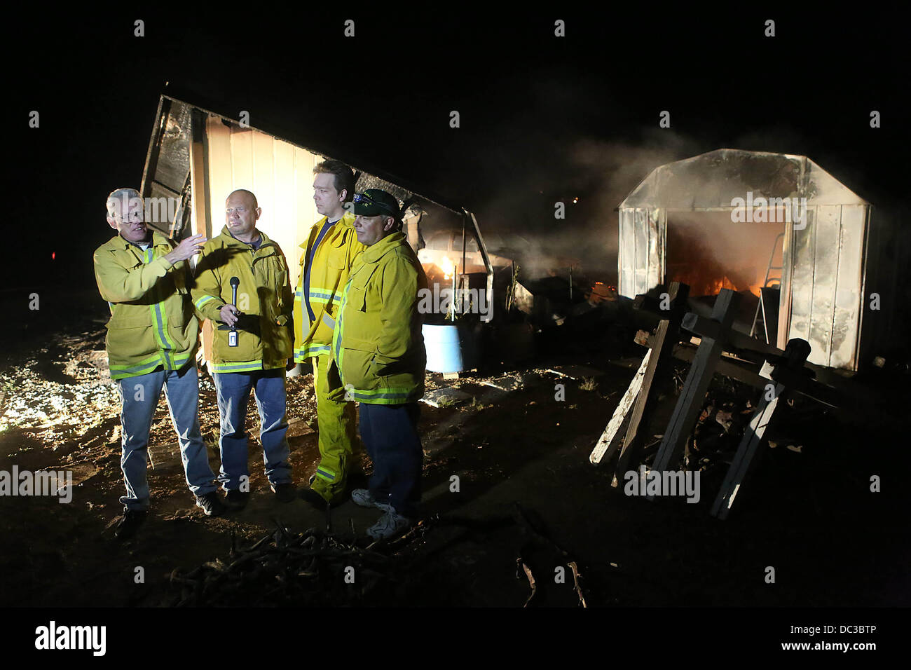Banning, CA, USA. 7th Aug, 2013. A fire official records an interview