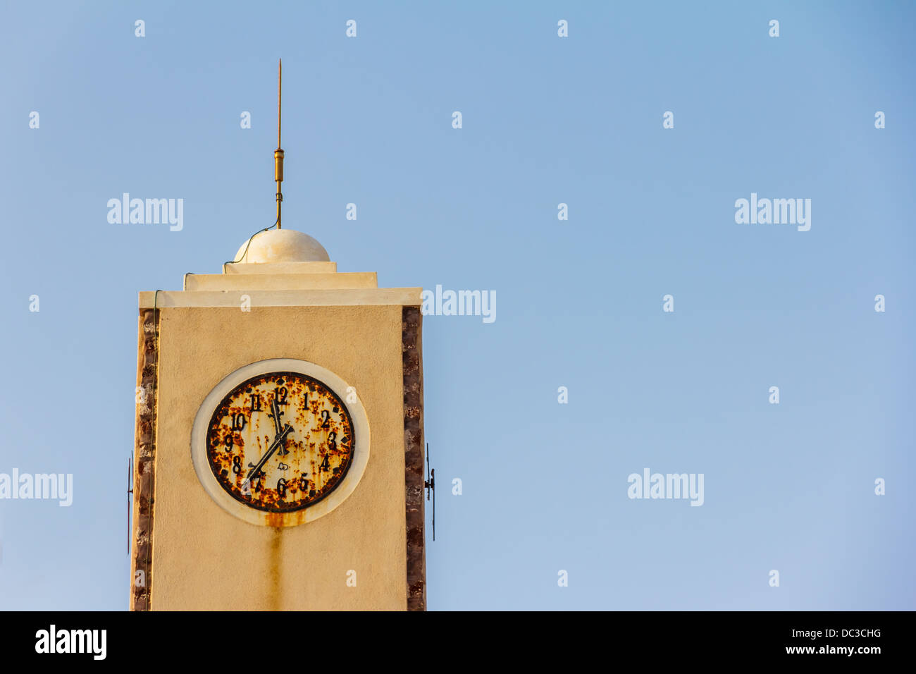 Old rusty city tower clock at Oia Santorini in Greece Stock Photo