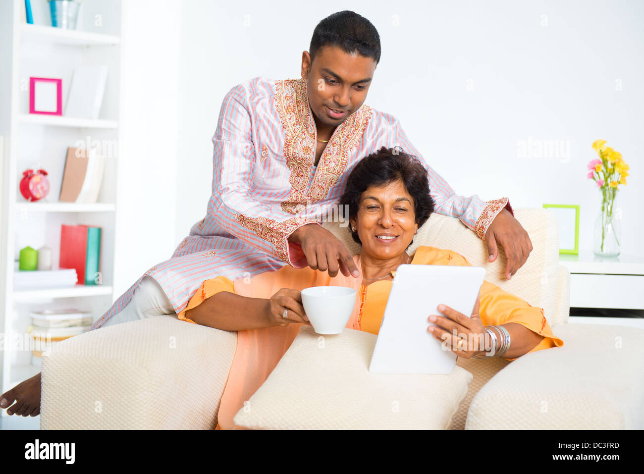 Indian family using computer tablet Stock Photo - Alamy