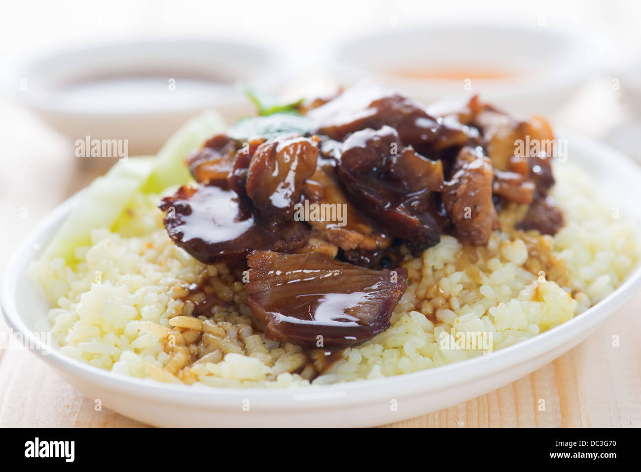 Slices of traditional Chinese marinated barbecue pork on dining table. Bbq pork Char Siew Rice Singapore cuisine. Stock Photo