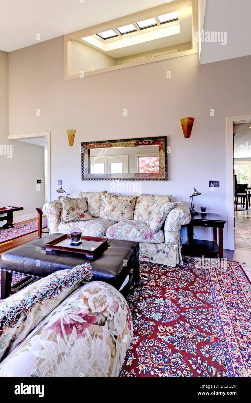 Living room with high ceiling with red rug and sofas Stock Photo - Alamy - High Ceiling Apartment Rug Ideas