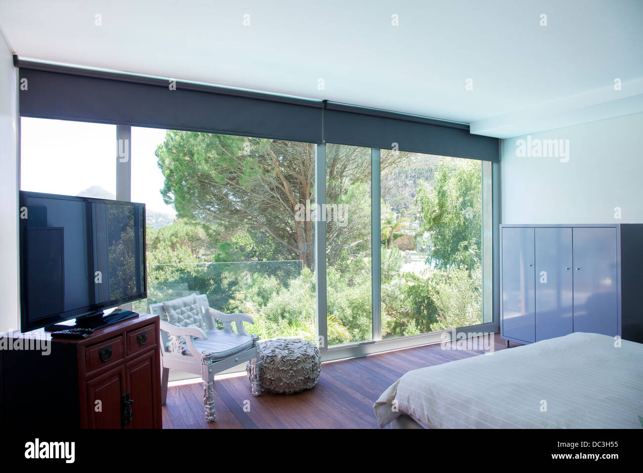 Modern bedroom with glass sliding doors Stock Photo