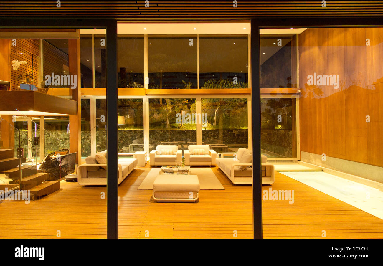 Illuminated modern living room at night Stock Photo Alamy