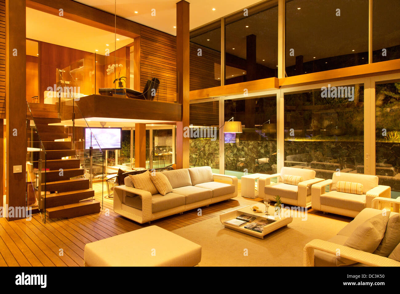 Illuminated modern living room at night Stock Photo