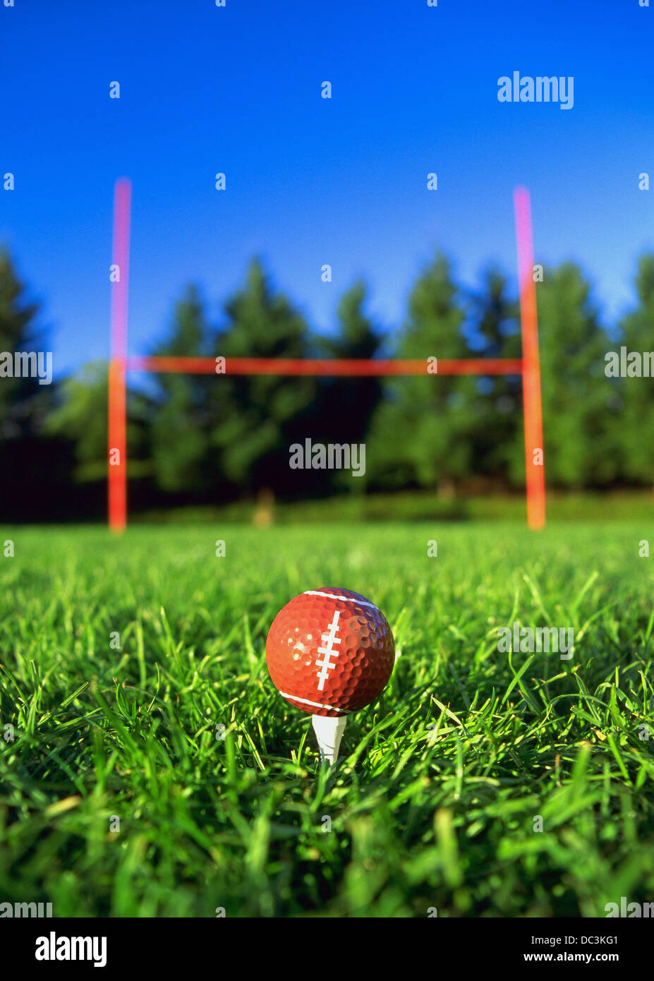 Golf ball on football field Stock Photo Alamy