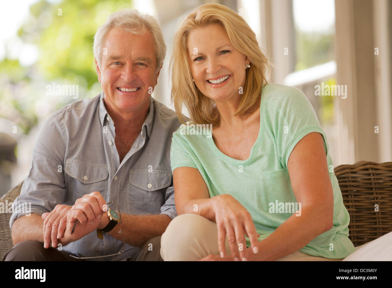 Portrait of smiling couple on patio Stock Photo