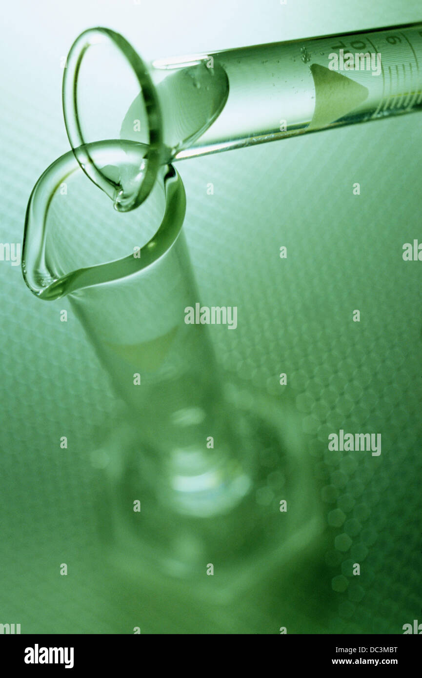 Pouring liquid into cylinder Stock Photo Alamy