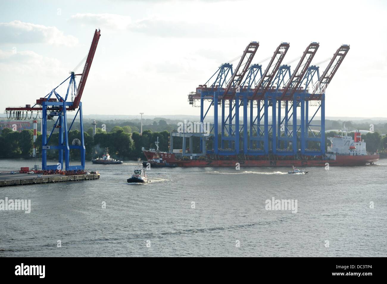 Four new container gantries are transported on a converted tanker ship ...
