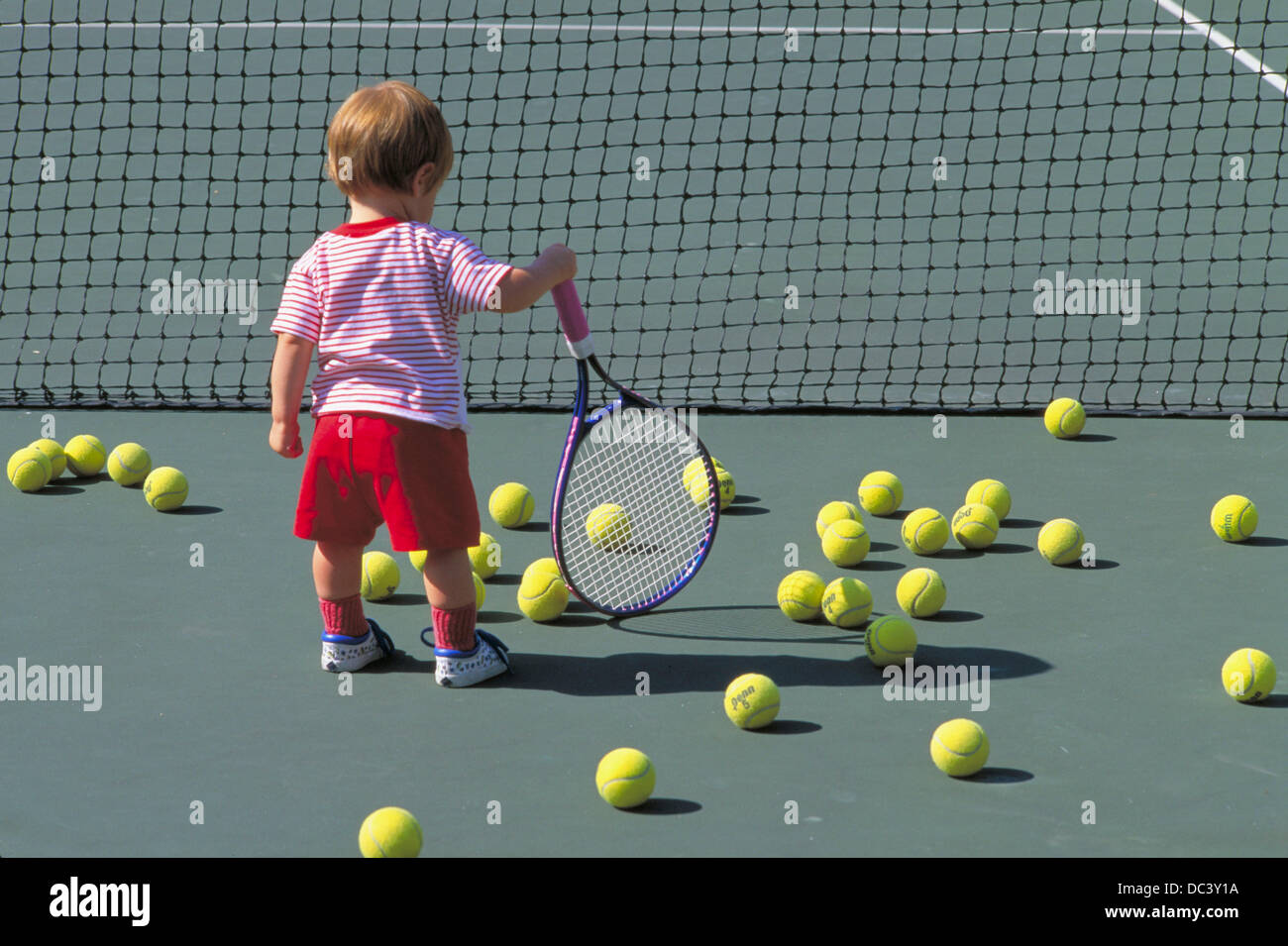 Young child holding tennis racquet Stock Photo Alamy