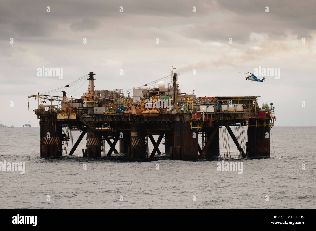 Offshore oil rig Petrobras VIII with helicopter landed/landing on deck ...