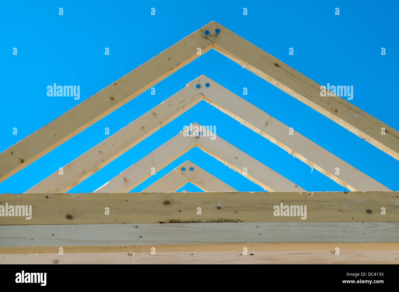 Rafters of the roof frame of a house under construction Stock Photo