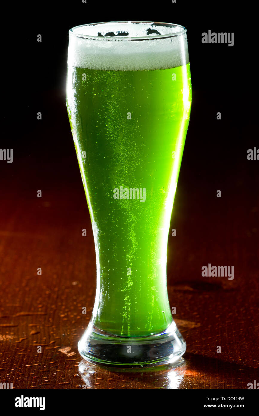 green beer isolated on a wooden bar, classic St. Patrick's day beverage