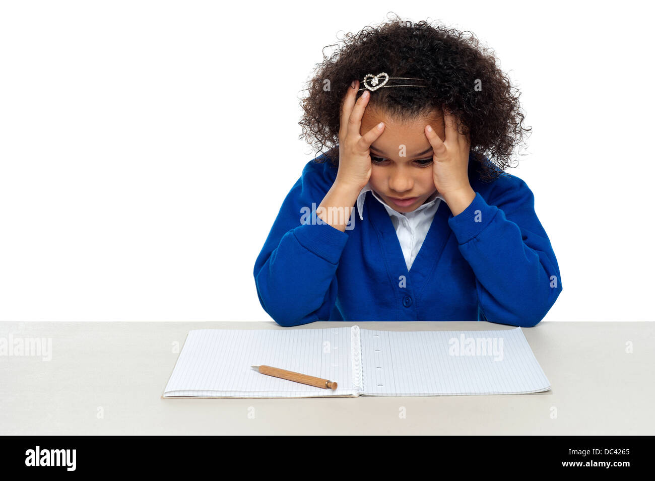 Stressed out primary girl child holding her head Stock Photo - Alamy