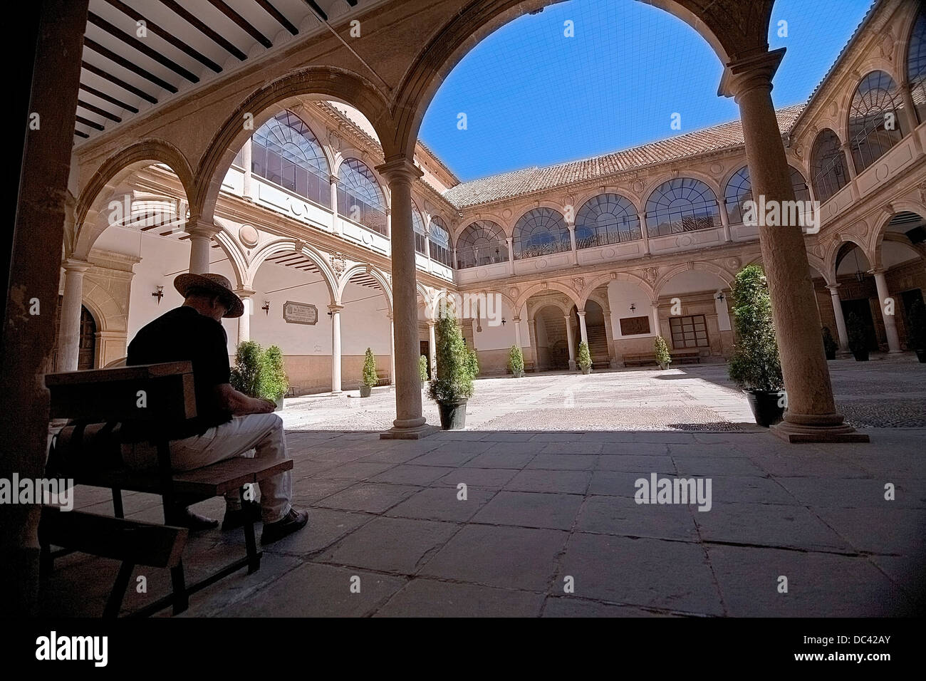 Tourist in the inner courtyard of the University of Baeza Antonio Machado, a World Heritage Site, Andalusia, Spain Stock Photo
