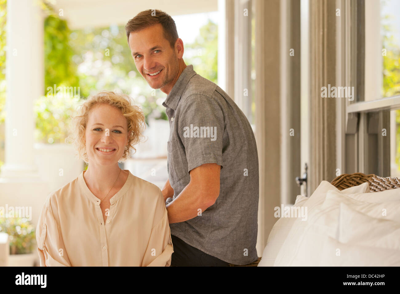 Portrait of smiling couple on porch Stock Photo - Alamy